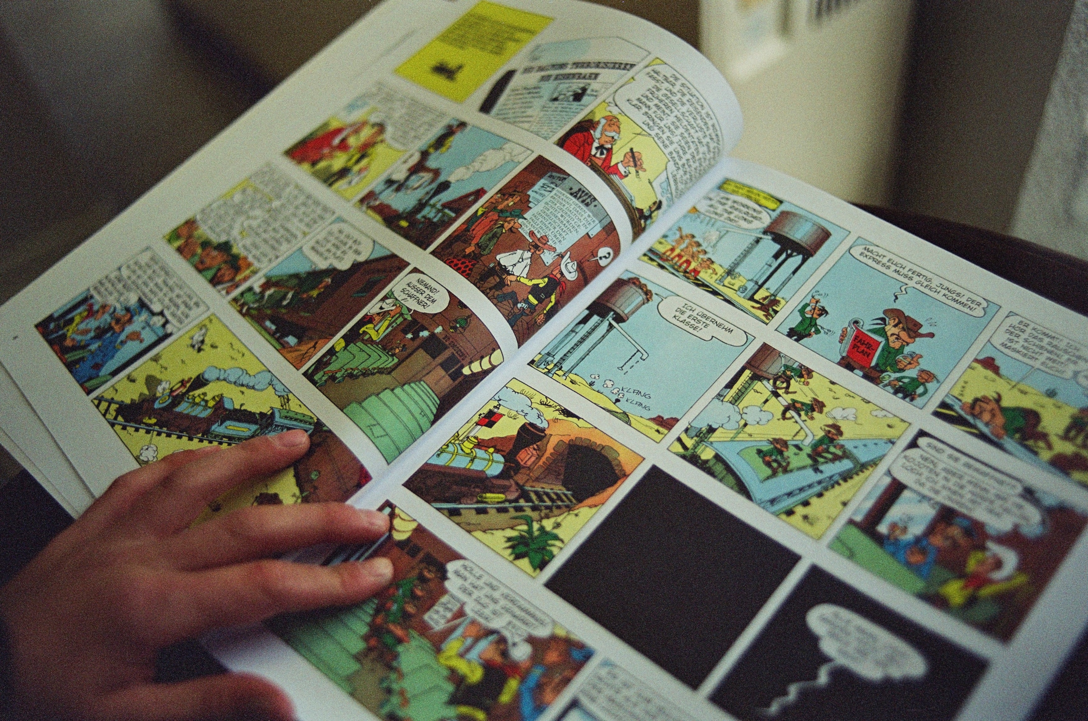 Open comic book with color illustrations