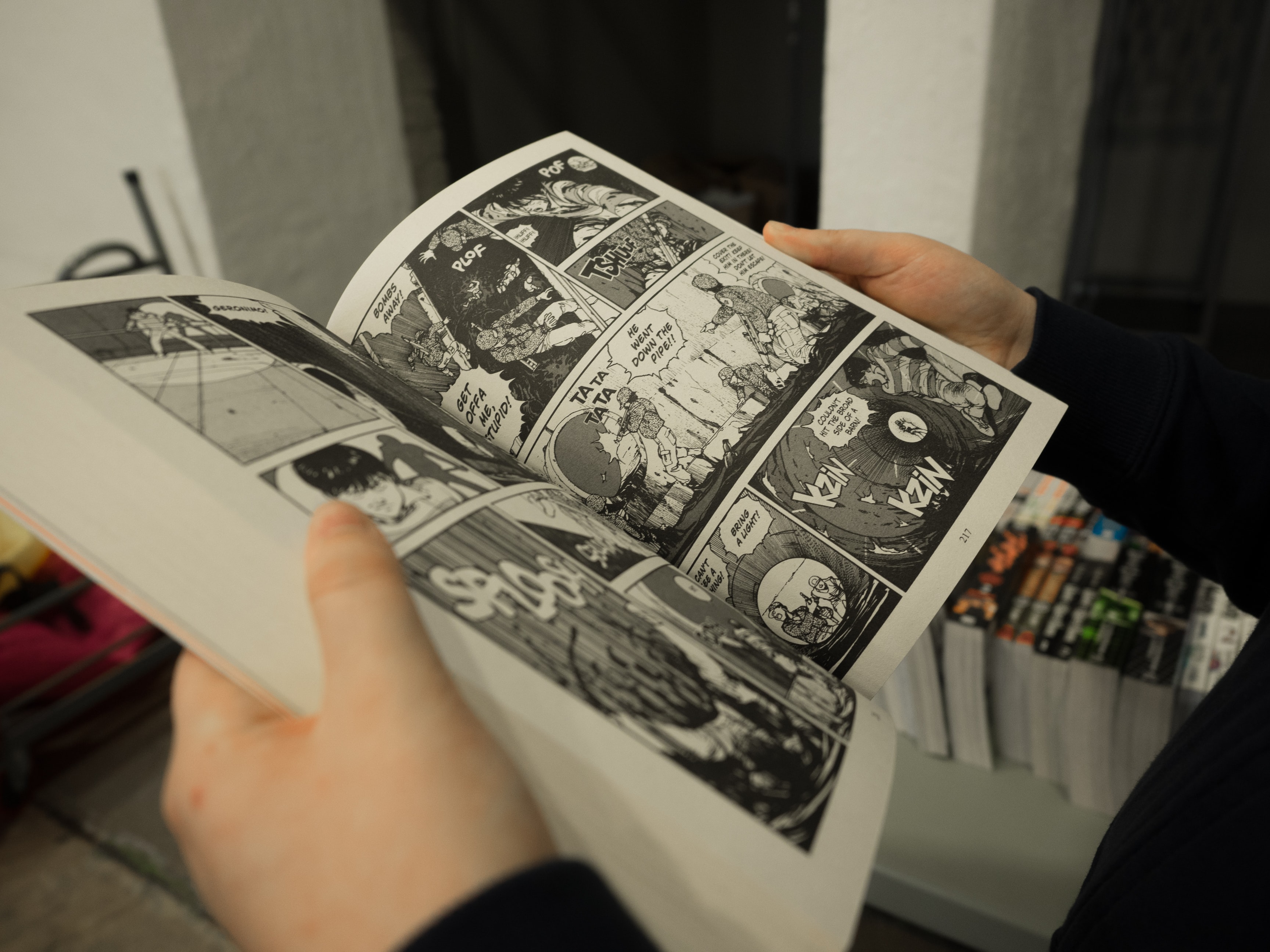 Open comic book with black and white illustrations